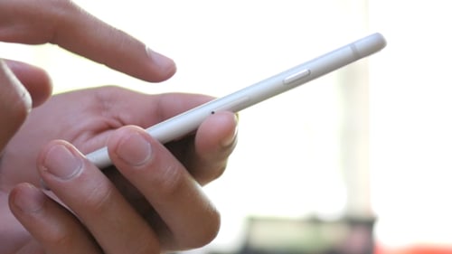 Hand Using Smartphone Close Up Indoors
