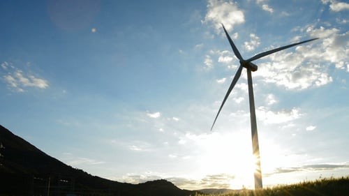 Wind Turbine Energy Moving at Sunset