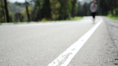 Woman Running Outdoors Checking Smart Watch