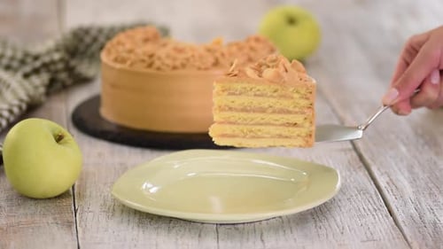 Serving Slice of Caramel Layer Cake with Apples