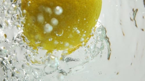 Vibrant Lemon Falling into Bubbling Refreshing Water