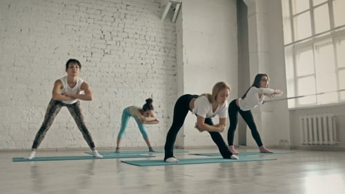 Women Stretching in Yoga Class in Studio