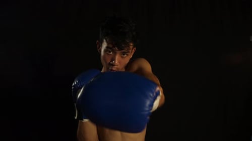 Man Boxing and Practicing Punches in Studio