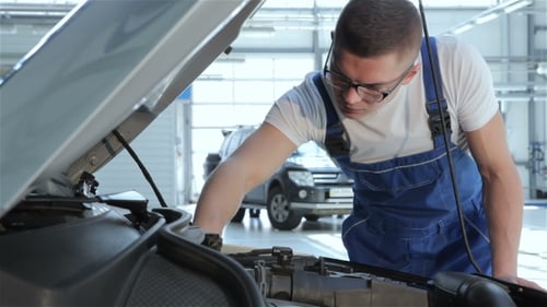 Mechanic Checks Up Serviceabillity Of The Car