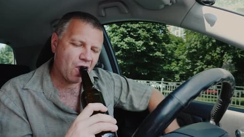 Adult Man Drinking in Car During Daytime