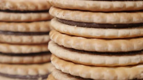 Sandwich cookies on pile tasty dessert close-up slow tilt 4K 2160p 30fps UltraHD footage - Sandwic