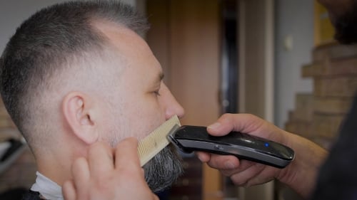 Bearded Man Getting Facial Hair Trimmed by Stylist
