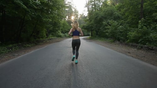 Athletic Girl Running At Road In Forest. Outdoors Fitness.