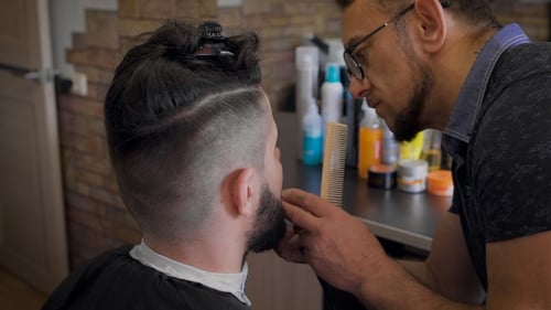 Barber Trimming Beard in Stylish Salon