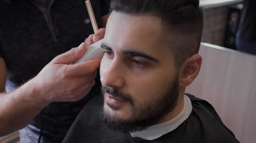 Barber Works With Clients Beard