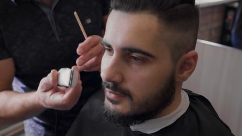 Barber Works On Client's Beard