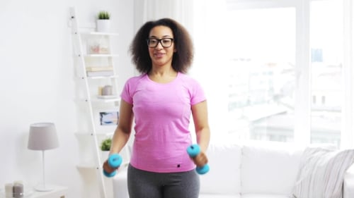 Woman Doing Dumbbell Workout in Bright Living Room