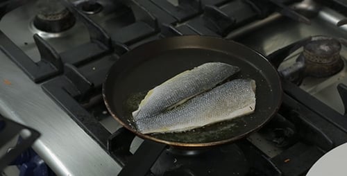 Chef Frying Fish Fillets in Pan