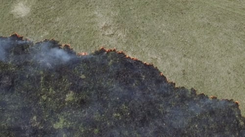 Aerial View of a Fire Consuming Grassy Field