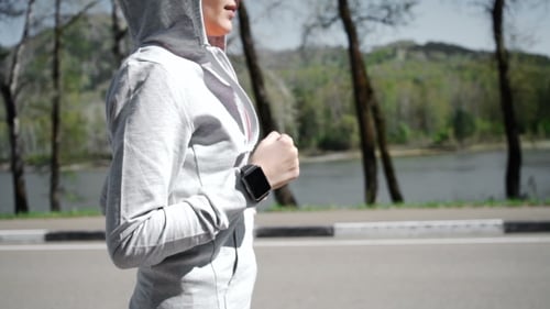 Health Sport Young Woman Run And Look Wear Smart Watch Device