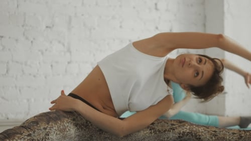 Two Women Practicing Yoga Splits in Bright Studio