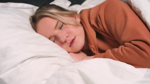 Close Up Portrait of Relaxed Woman Sleeping on a White Pillow in Bed