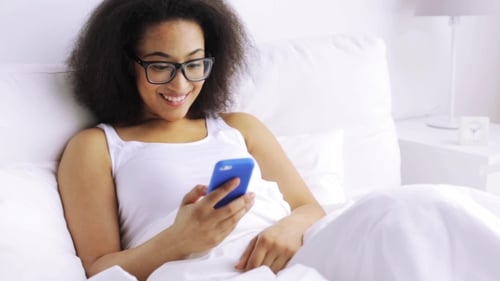 African Woman With Smartphone In Bed At Home 81