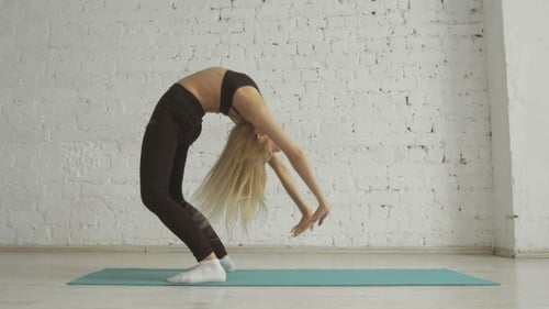 Beautiful Young Woman Doing Yoga Exercise, Stretching, Standing In Bridge Pose