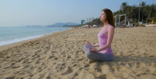 Woman Meditate on the Beach in Slow Motion