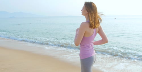 Woman Runner Running on Beach Road