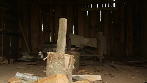 Axe Chopping Wood in Rustic Wooden Building