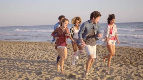 Young People Running On The Beach