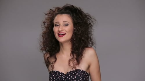 Woman With Curly Hair Playing in Studio