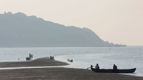 Misty Tropical Seascape With Boats And Fishermen Silhouettes