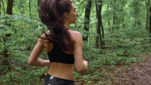 Young Athletic Sporty Girl With Long Hair Training In Green Forest