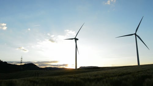 Wind Turbines Spinning Silently at Sunset
