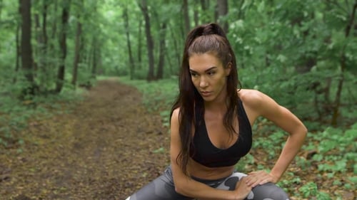 Slim Fitness Woman On a Forest Path