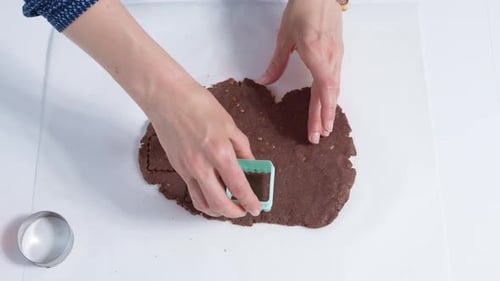 Extruding on the dough with a cookie baking dish. Close-up. 4K.