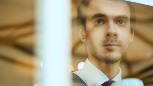 Young Adult Man Drinking Coffee Indoors