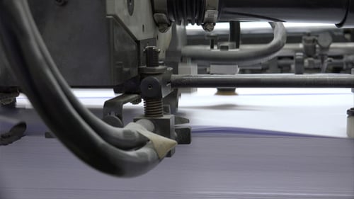 Industrial Machine Processing Paper in Factory Close Up