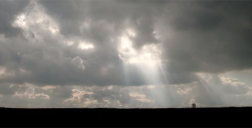 Sunlight Beams Through Dramatic Clouds