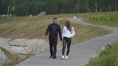 Couple Walking Along a Path in a Park