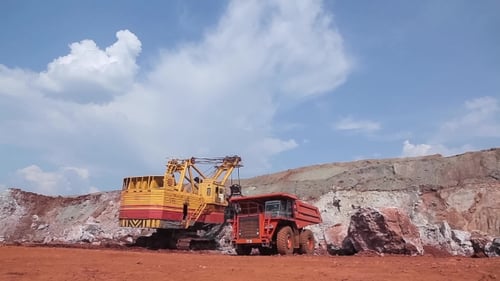 Excavator Loads Ore Into Dump-truck.