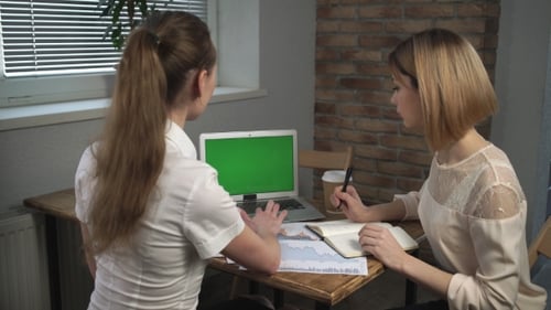 Women Collaborating on Laptop with Green Screen