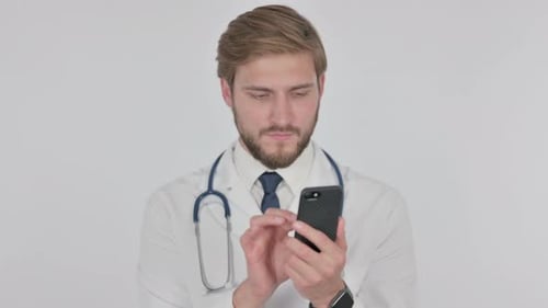 Doctor Using Mobile Phone in Bright Studio