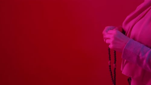 Woman Holding Islamic Prayer Beads in Hands