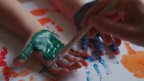 Child's Hand Painted with Bright Green Paint