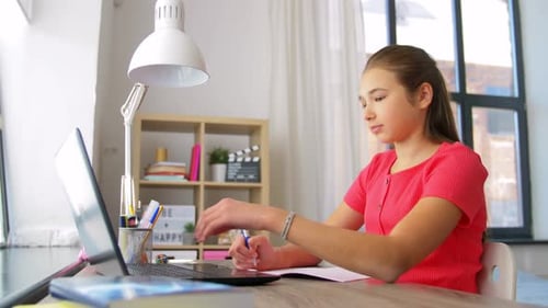 Girl Studying at Desk with Laptop and Notes