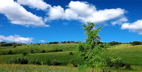 Rolling Green Hills with Blue Sky and Clouds