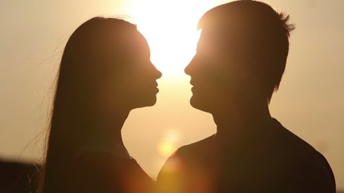 Romantic Couple Silhouette Kissing in the Sunrise
