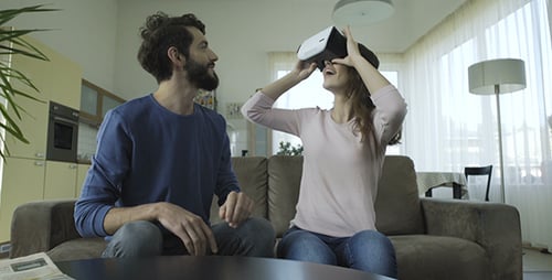Couple Enjoying Virtual Reality Headset at Home