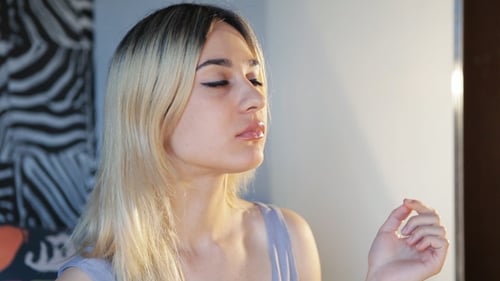 Young Woman Eating a Potato Chip Indoors