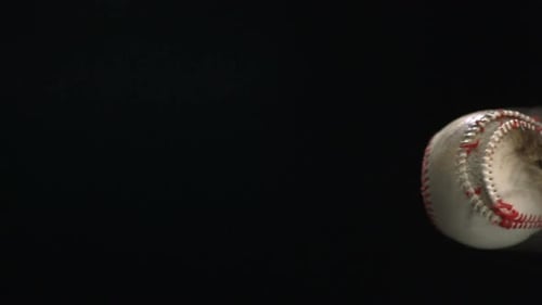 Baseball flying with dust in close up