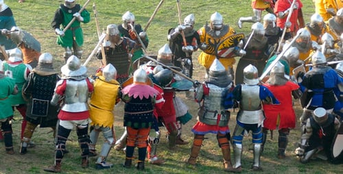 Medieval Battle Reenactment on Grassy Field