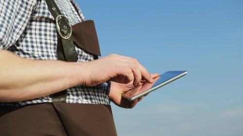 Young Man Uses a Digital Tablet